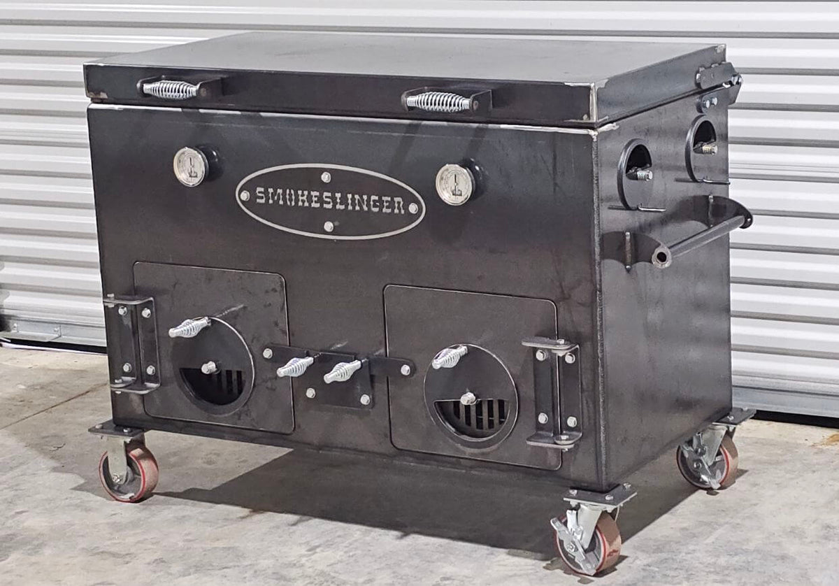 image of the front view of a smokeslinger smoker on a concrete floor with tin on the wall behind it