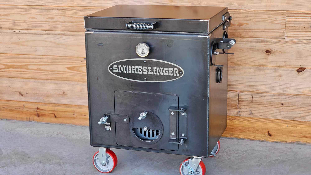 image of the top view of a smokeslinger smoker sitting on concrete with a natural stained wood wall in the bacground