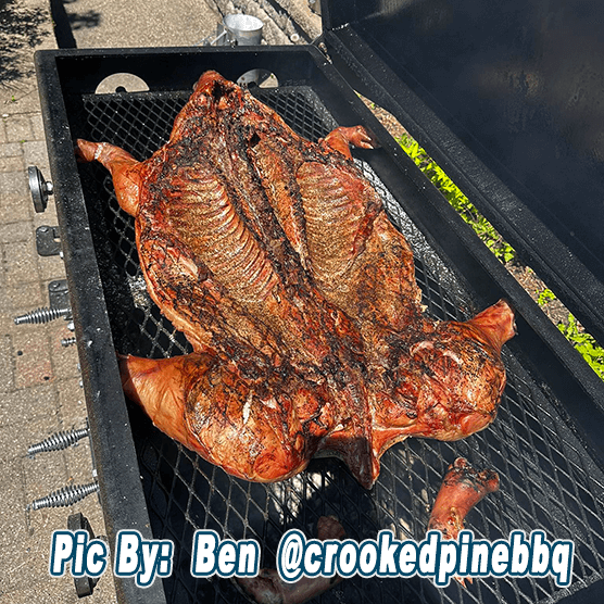 a whole hog being cooked by ben from crookedpine bbq on his full size smokeslinger
