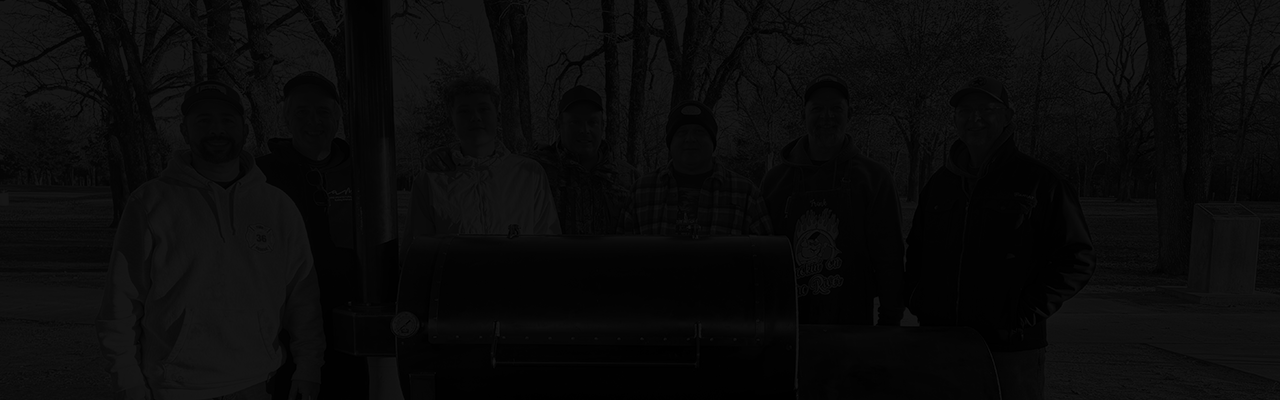 dark banner with happy guys standing behind the Liberty94 offset smoker