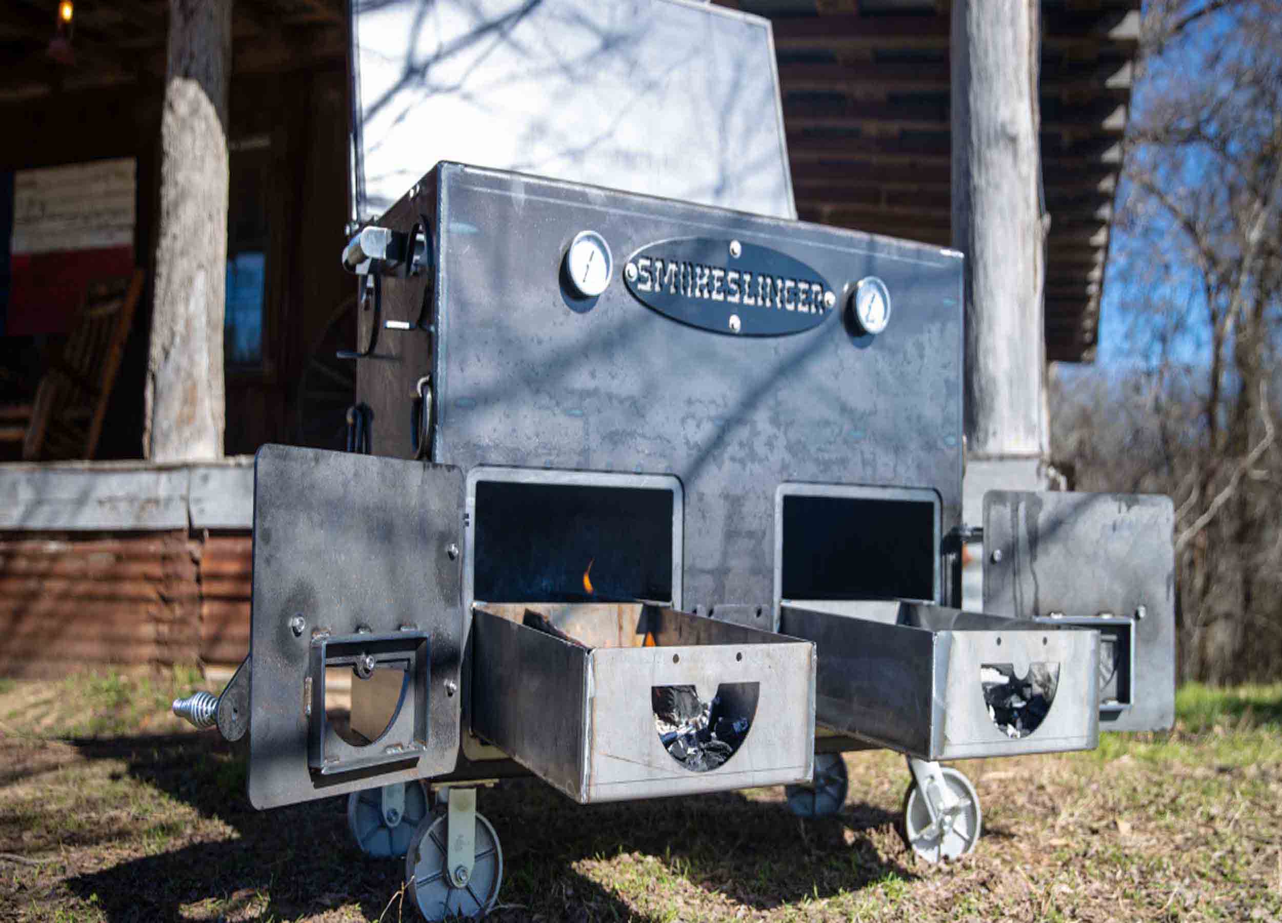 image of the top view of a smokeslinger smoker sitting on outside in front of a porch in the background