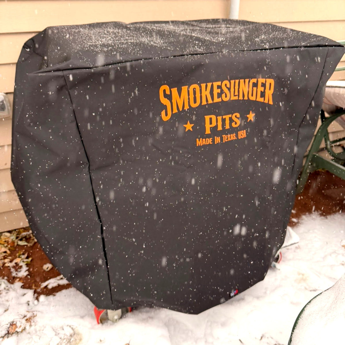 Mini Smokeslinger Cover on a Mini Smokeslinger during snowfall, shedding snow and ice