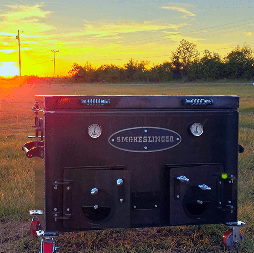 a smokeslinger smoker in the bottom right corner with a sunset and a house in the background